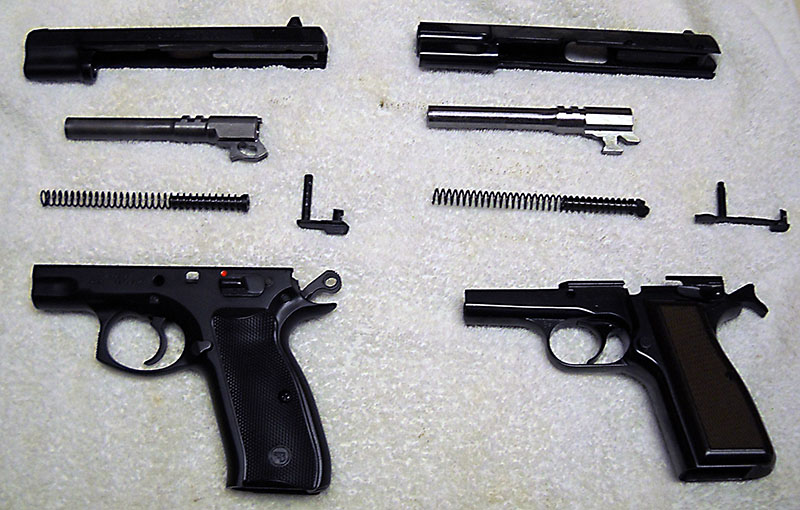 two field-stripped pistols, left: CZ 75B, right: Browning Hi-Power